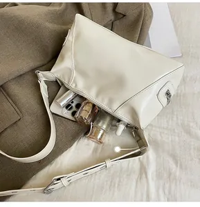 Top view of white soft leather tote showing spacious interior for phone and cosmetics
