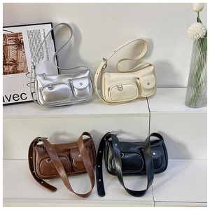 Close-up of small square PU leather bags in silver, cream, brown and black with pockets