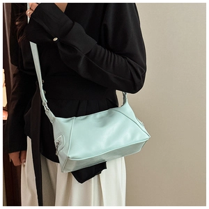Detail of mint green PU leather small square bag with matching wide shoulder strap