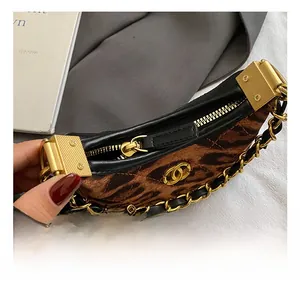 Detailed view of leopard print plush bag with gold double C logo and metal chain strap
