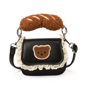 Mini black leather crossbody bag with lace detail and brown plush bear handle decoration