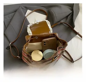 Detail view of the spacious inner compartment and pocket of the retro plaid child backpack