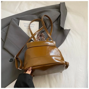 Polished brown PU leather mini backpack showing glossy texture and drawstring detail