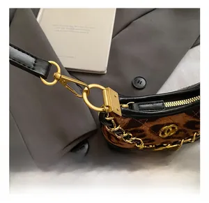 Detail of high-quality matte gold clasp and chain on leopard print quilted mini bag