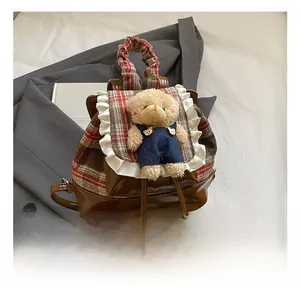 Detail of cute bear backpack featuring vintage plaid flap and white lace trim decoration