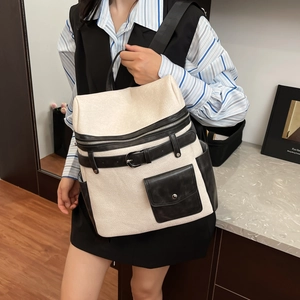 Chic cream and black contrast backpack with silver zippers and large capacity for travel