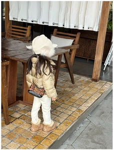 Detail of leopard print crossbody bag with chain strap for children in outdoor setting