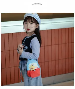 Detail of color-block mini messenger bag for kids with cute yellow star plush charm