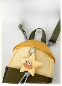 Detail view of the nylon crossbody bag with color-block design and star plush charm