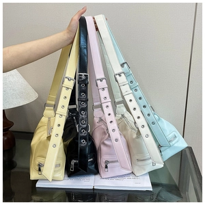 Detail of five colorful soft PU leather tote bags with adjustable metal eyelet straps