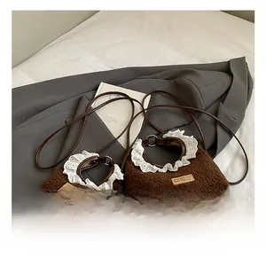 Detailed view of brown plush mini crossbody bags with white lace trim and leather straps
