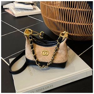 Detail of a mini quilted leopard print shoulder bag on a vintage book with chain strap