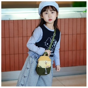 Detail of kids color-block crossbody bag with star pendant and adjustable strap