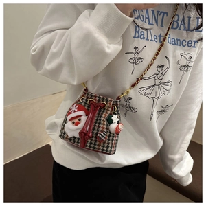 Detail of kids plaid bucket bag with plush Santa decorations and chain strap