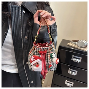 Close-up of kids plaid Christmas bucket bag with Santa motifs and chain strap