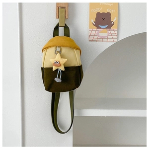 Close-up of contrast color mini bag with cute plush star charm hanging on wooden hook