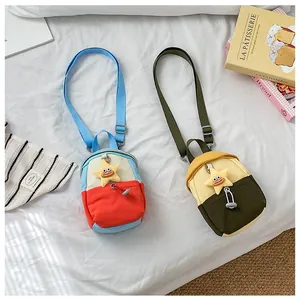 Close-up of canvas crossbody bags with contrast colors and star plush charms