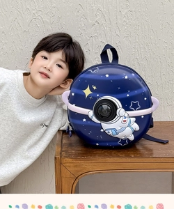 Close-up of hard shell astronaut toddler backpack featuring a 3D bubble window and space art