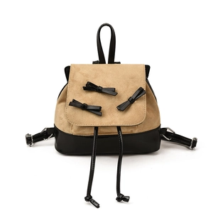 Mini backpack with khaki suede flap, black leather bows and drawstring on white background