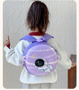 Detail view of purple astronaut hardshell backpack with a round transparent window feature