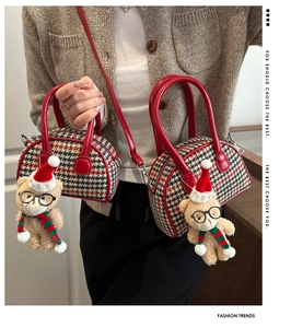 Detail of kids red houndstooth shell bag with plush bear pendant and leather straps