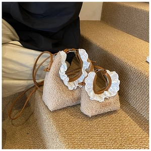 Detail of beige faux shearling bags with lace trim and leather straps in two sizes