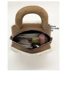 Internal capacity of mini plush handbag showing lipstick and cosmetics storage