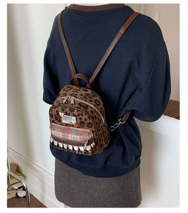 Back view of retro leopard print children's backpack featuring delicate lace trim detail