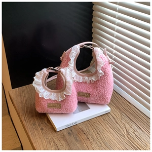 Detail of pink faux shearling mini bags with white lace trim and bear brand patch