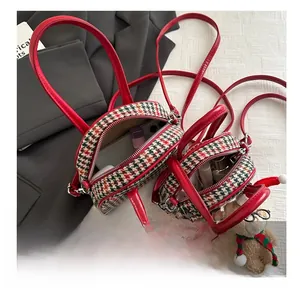 Detail showing two sizes of houndstooth shell bags and interior storage capacity