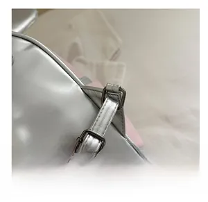 Close-up of adjustable silver metal buckle and pink leather strap on kids backpack