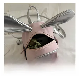 Interior view of pink rabbit ear backpack showing storage for phone and umbrella
