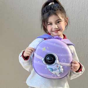 Toddler purple astronaut hard shell backpack with 3D window shown on a young girl