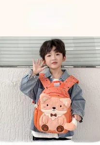 Detailed view of an orange cartoon fox kids backpack featuring plush texture and soft mesh pockets