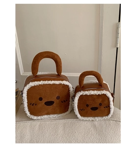Detail view of large and small fuzzy bear plush handbags with soft white faux fur trim