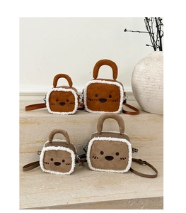 Detail of four cute cat-face crossbody bags with faux fur trim in caramel and khaki tones