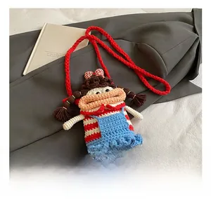 Detail show of a handmade crochet crossbody bag featuring a funny big mouth doll character
