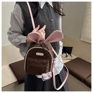 Detail of cute bunny ears and fashion label on leopard print toddler backpack