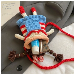Handmade crochet doll phone bag showing inner capacity for cosmetics and a smartphone