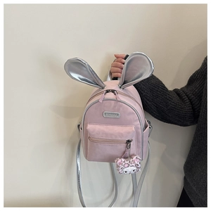Detailed view of pink toddler backpack with silver bunny ears and faux fur charm