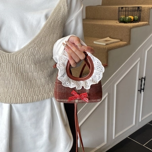 Plaid wool mini girl's handbag with white lace trim and red bow, crossbody strap