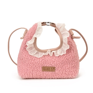 Pink sherpa crossbody bag for girls with lace trim and leather patch on white background
