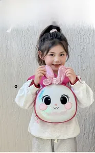 Toddler girl wearing pink sequin rabbit hard shell backpack on a white background