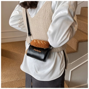 Detail view of a cute cookie-shaped plush crossbody bag with black leather and brown fur