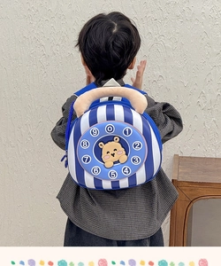 Detail of a kids backpack featuring a vintage blue telephone dial and plush hamster head
