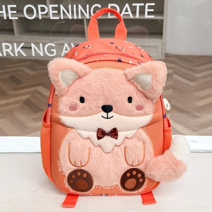 Detail of orange fox backpack featuring plush ears, 3D tail, and soft faux fur texture