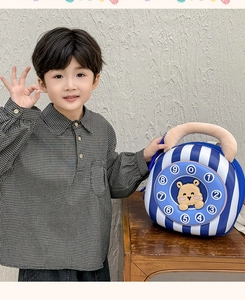 Close-up of cute vintage telephone style crossbody bag with cartoon bear on a wooden table