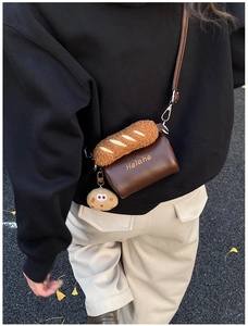 Detail of children's plush cookie shoulder bag with cute baguette and cookie charms