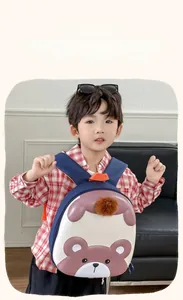Navy blue children's backpack with cream shell and cute brown bear print on model