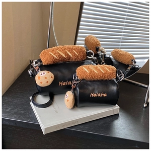 Detail view of mini plush cookie cylinders with Helahe logo and faux leather finish